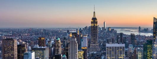 New York City. Manhattan downtown skyline with illuminated Empire State Building and skyscrapers at dusk. USA.