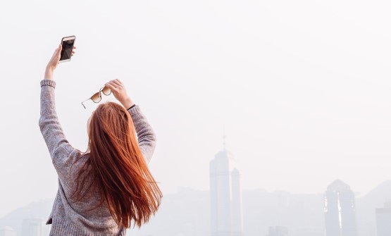 Woman taking picture infront of skyline